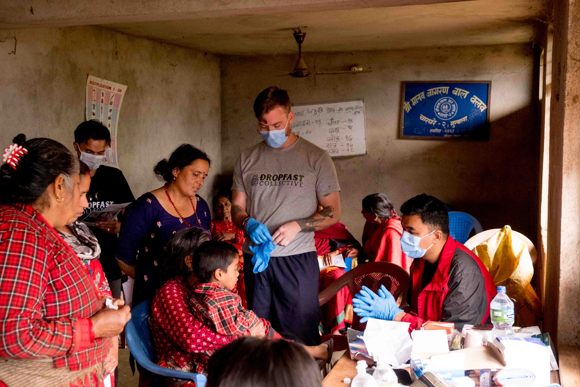 a group of people standing around a table