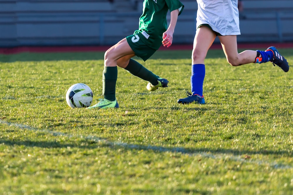 a couple of kids playing a game of soccer