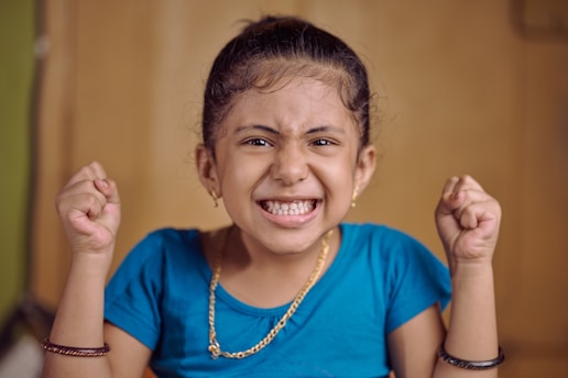 a little girl with a big smile on her face