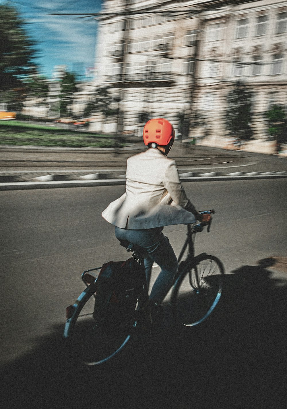 a person riding a bike down a street