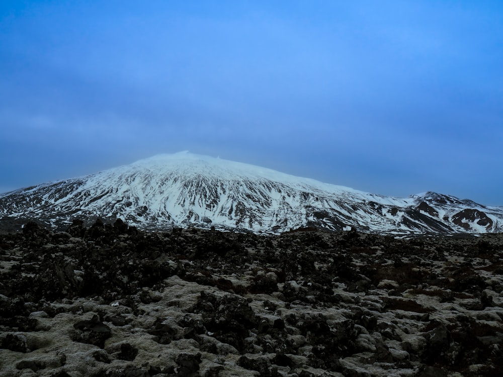 a mountain covered in snow on a cloudy day