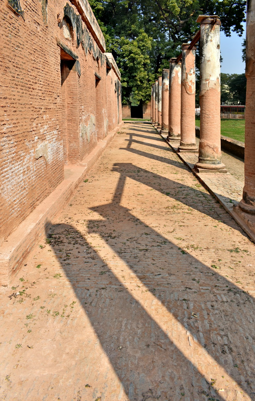 a long line of stone pillars in a park