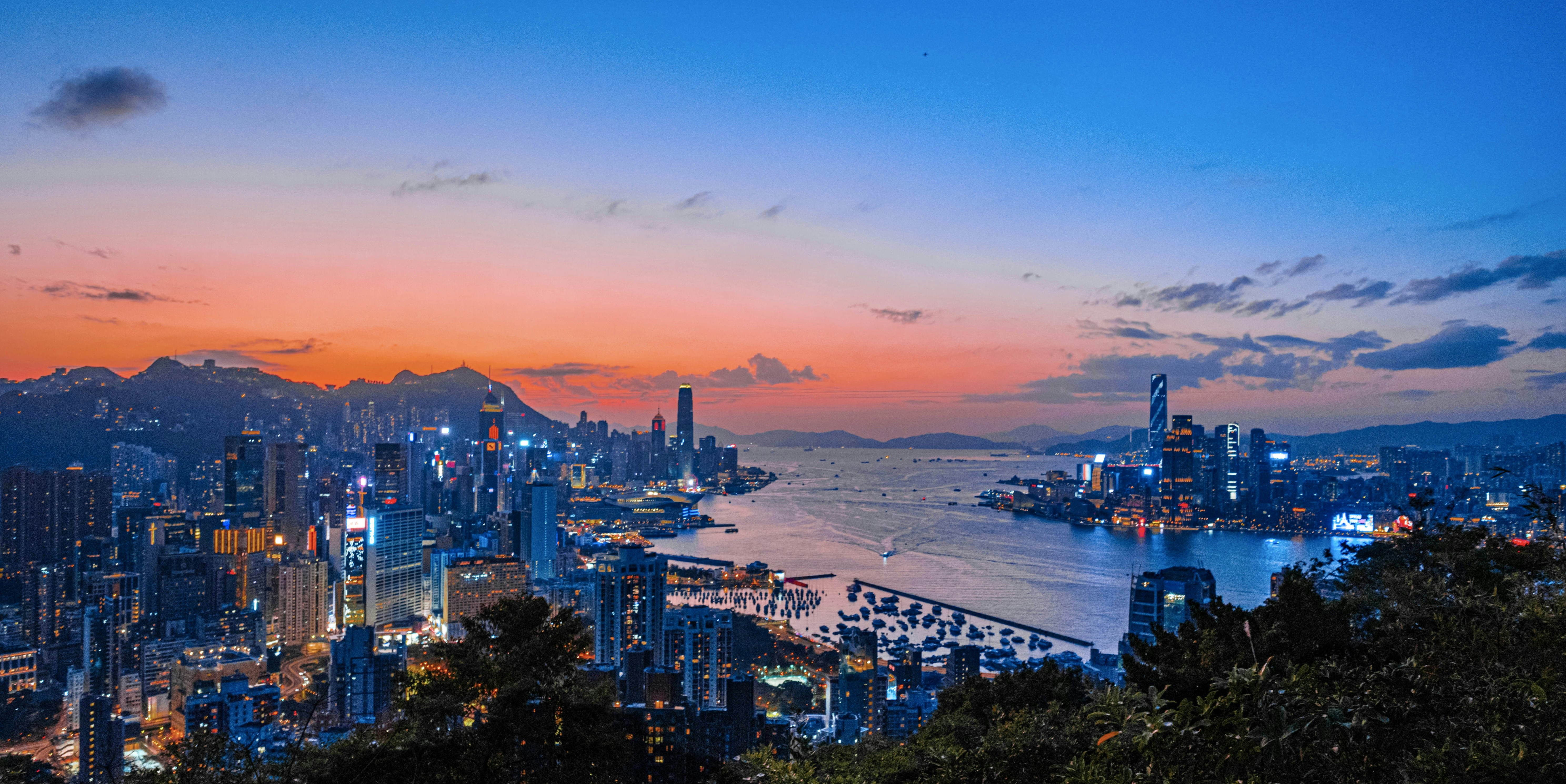 a view of a city at night from the top of a hill