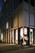 Security guard attentively monitoring a commercial building entrance at dusk