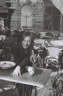 A smiling woman enjoying a healthy meal outdoors, symbolizing wellness and vitality.