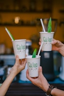 Smiling team members celebrating a project success with coffee cups