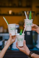 Team members celebrating a successful product launch with high-fives and coffee mugs.