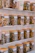 A cozy wooden shelf filled with jars of dried mountain herbs and colorful tea blends.