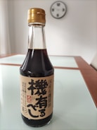 A selection of soy sauce bottles with chopsticks.