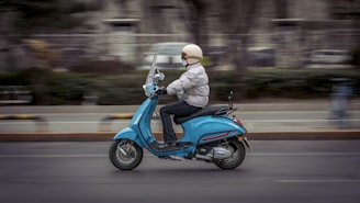 a person riding a scooter on a city street