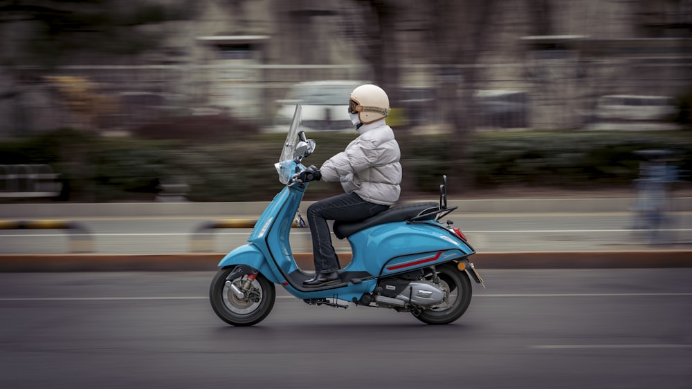 a person riding a scooter on a city street