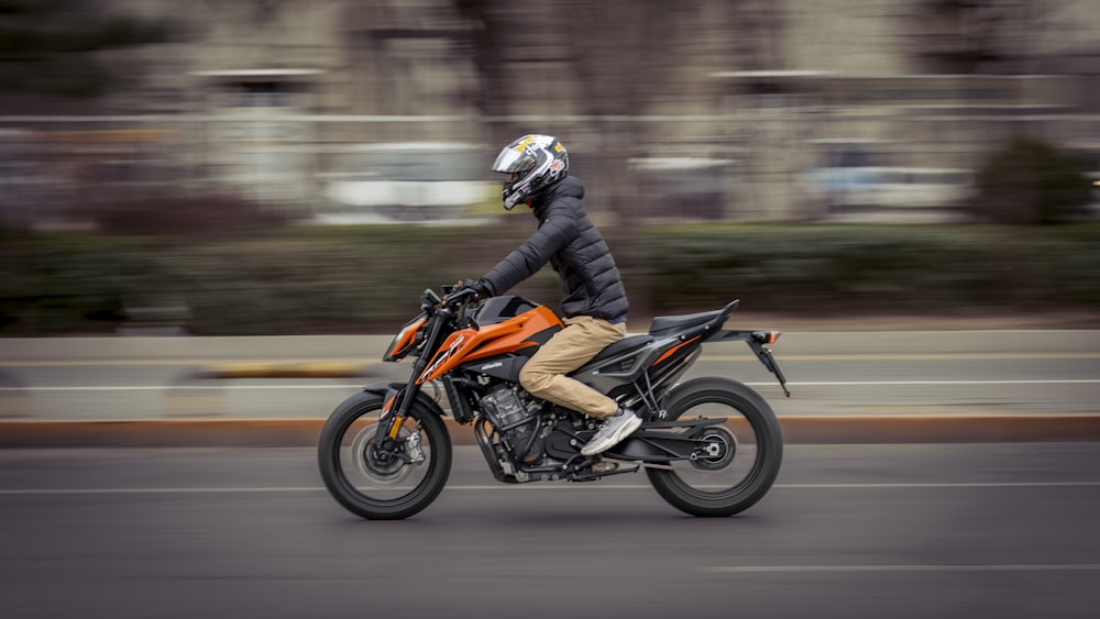 a man riding a motorcycle down a street