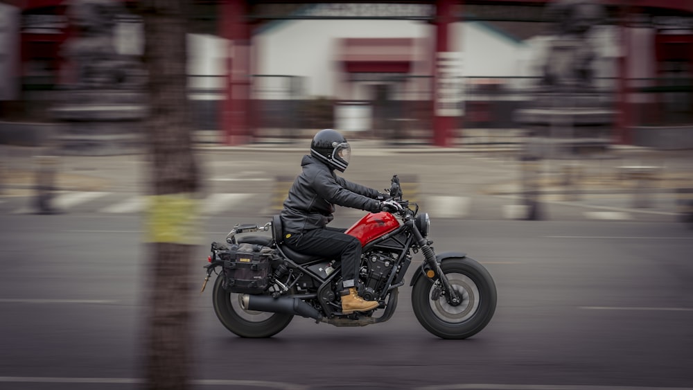 a man riding a motorcycle down a street