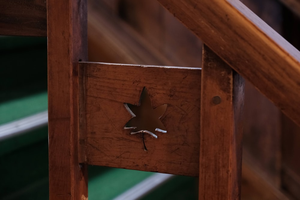 a close up of a wooden bench with a star on it