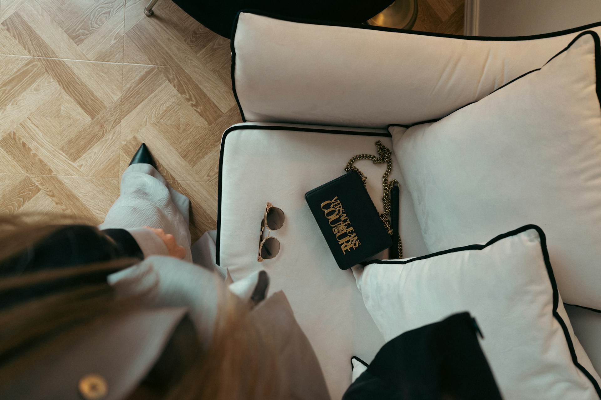 a person sitting on a couch with a book on it