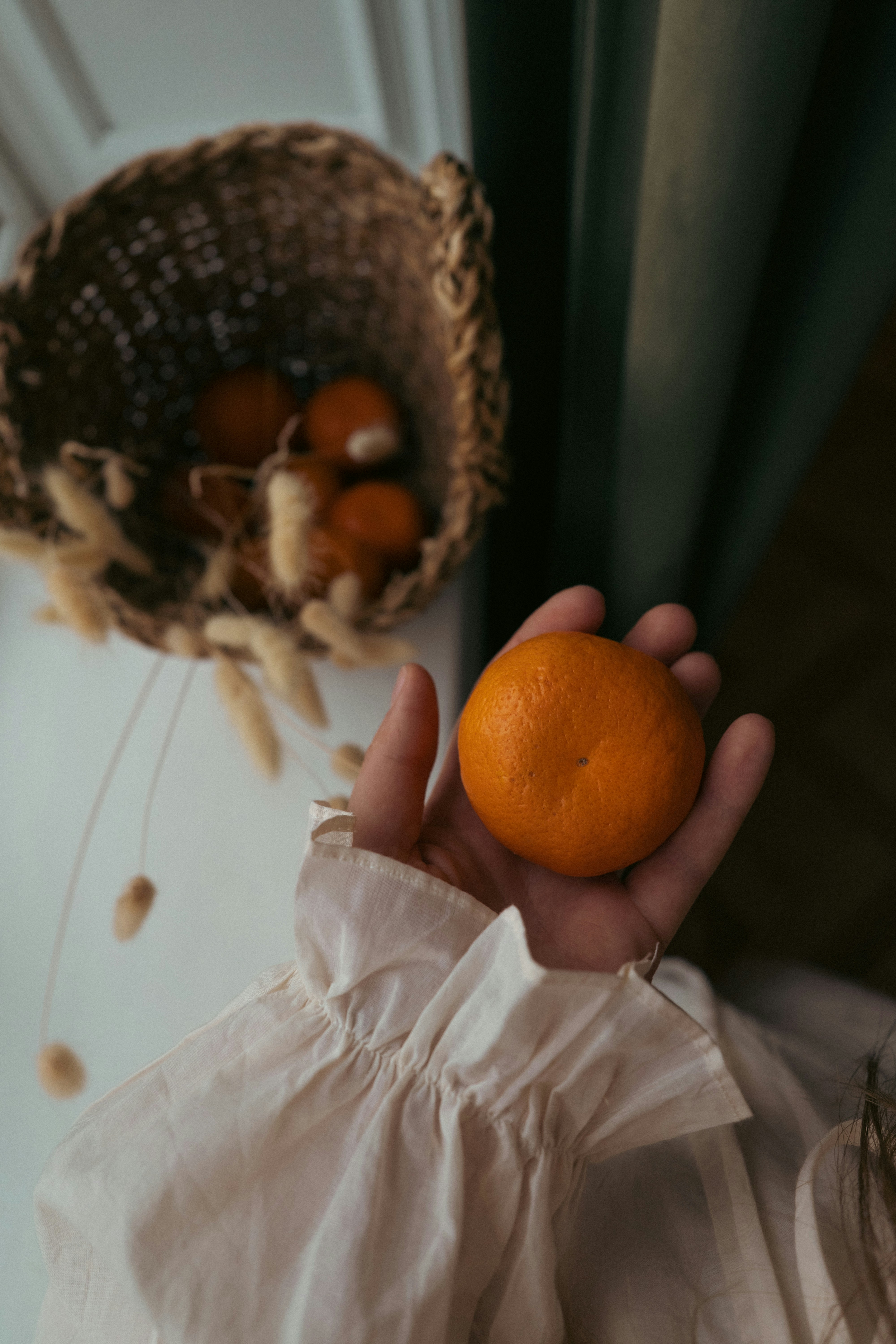a person holding an orange in their hand