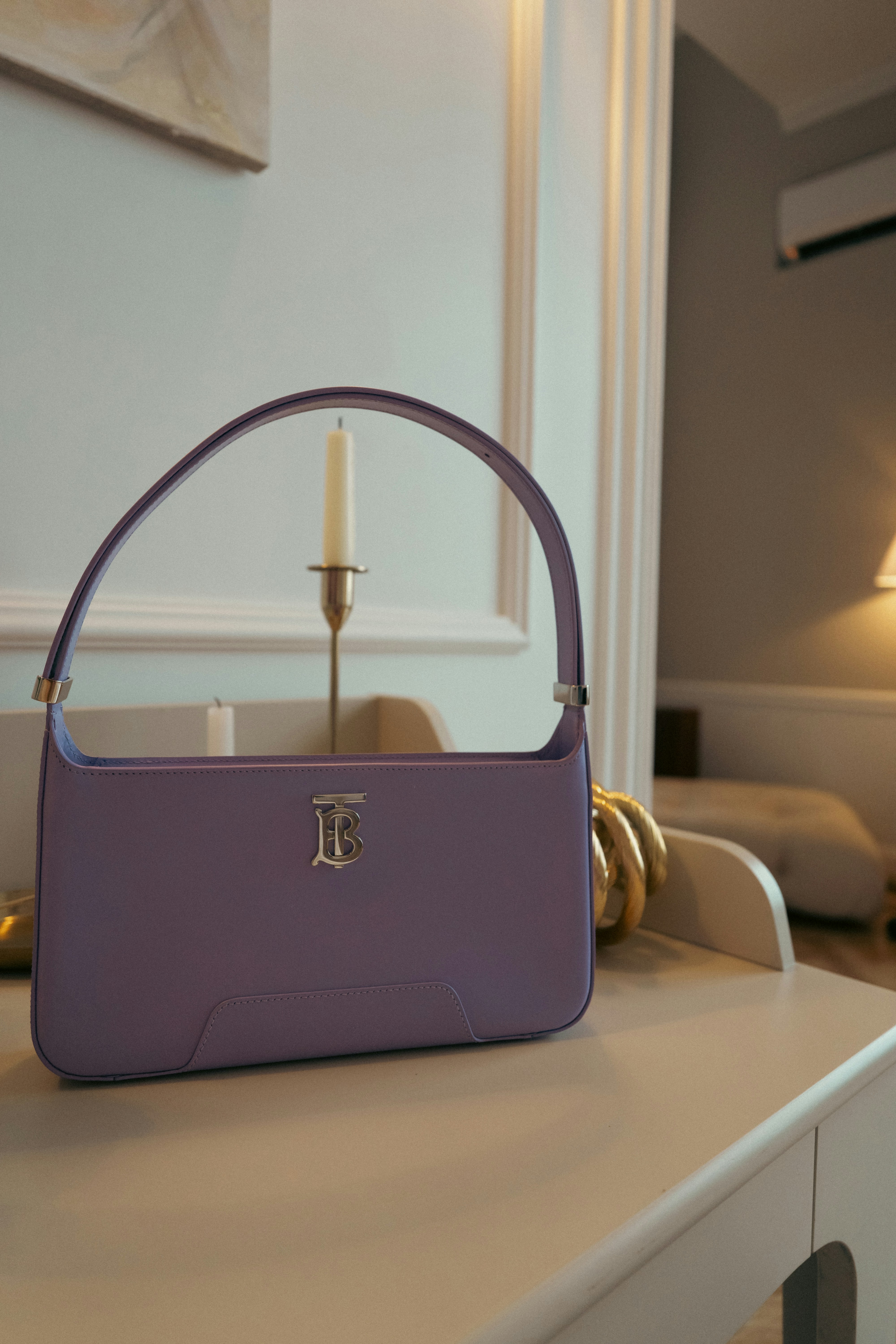 a purple purse sitting on top of a white table