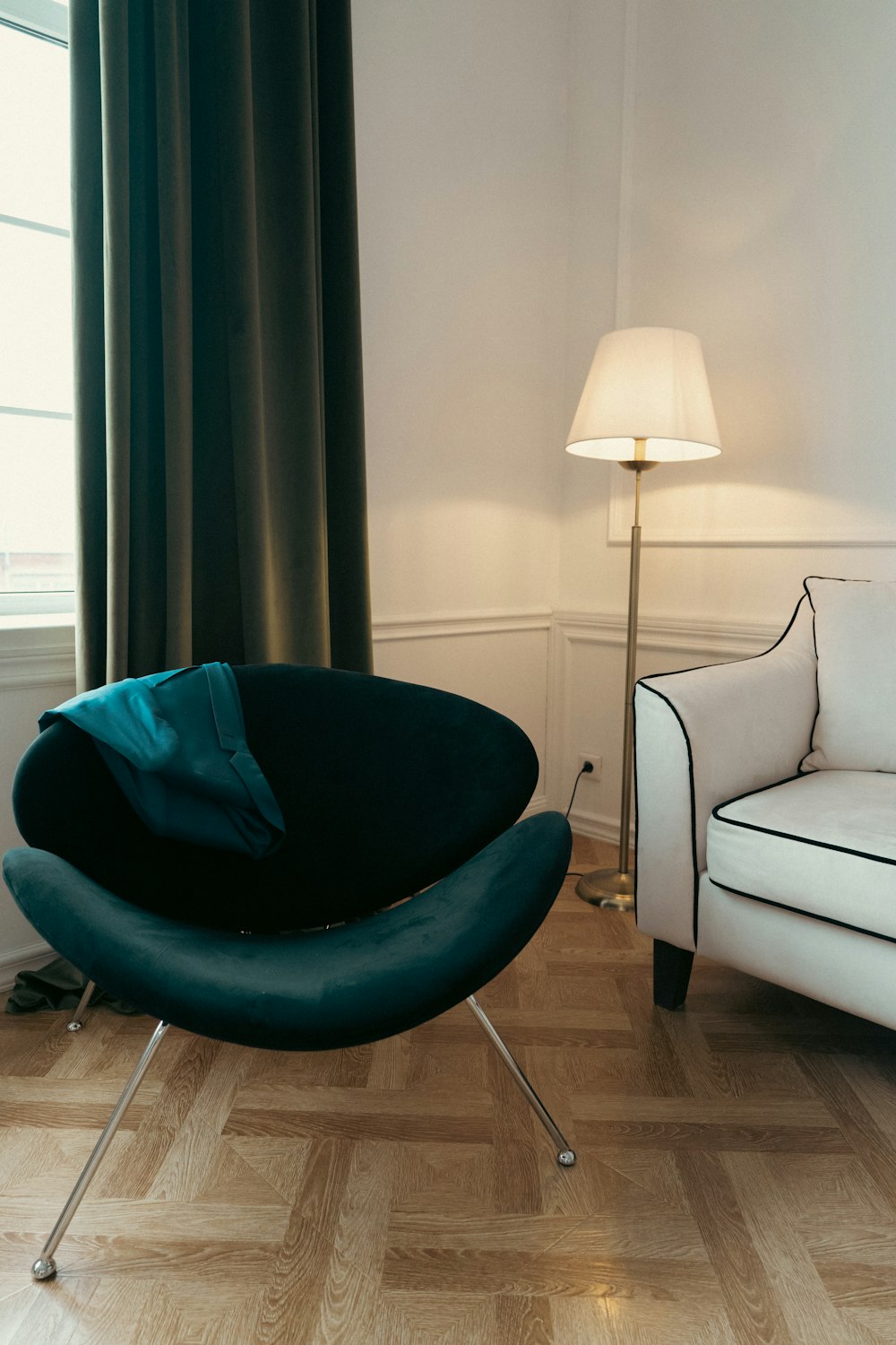 a living room with a chair and a lamp