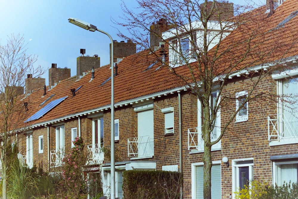 a row of brick houses with a street light in front of them