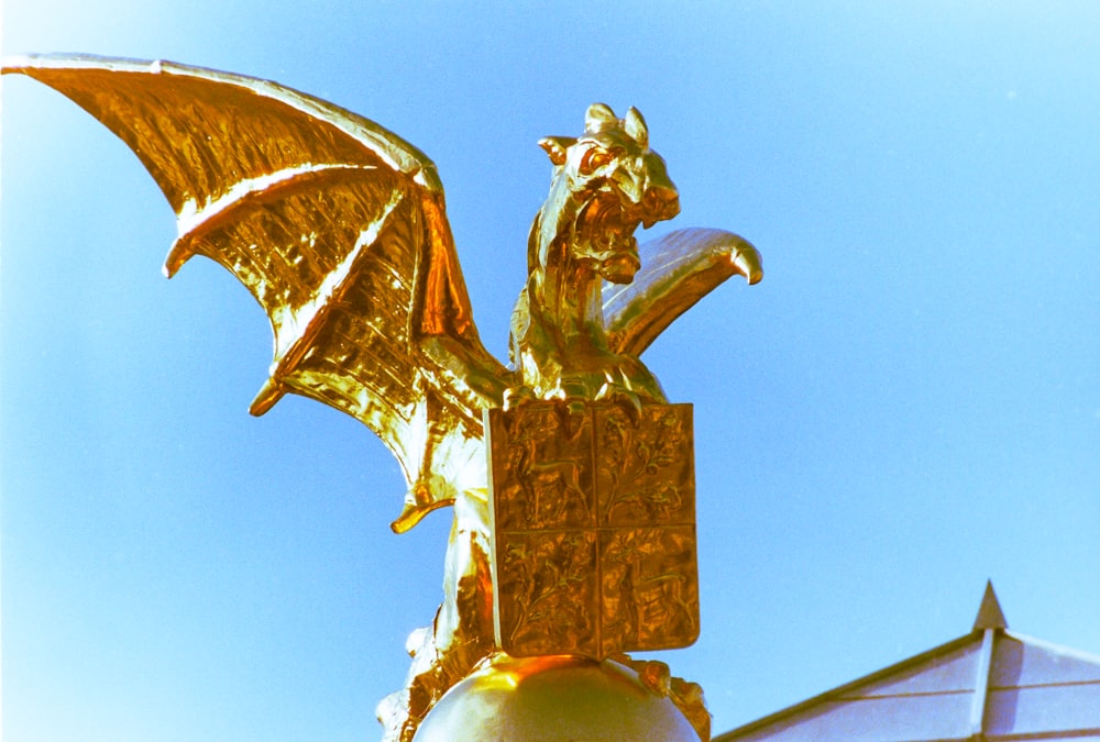 a golden dragon statue on top of a building