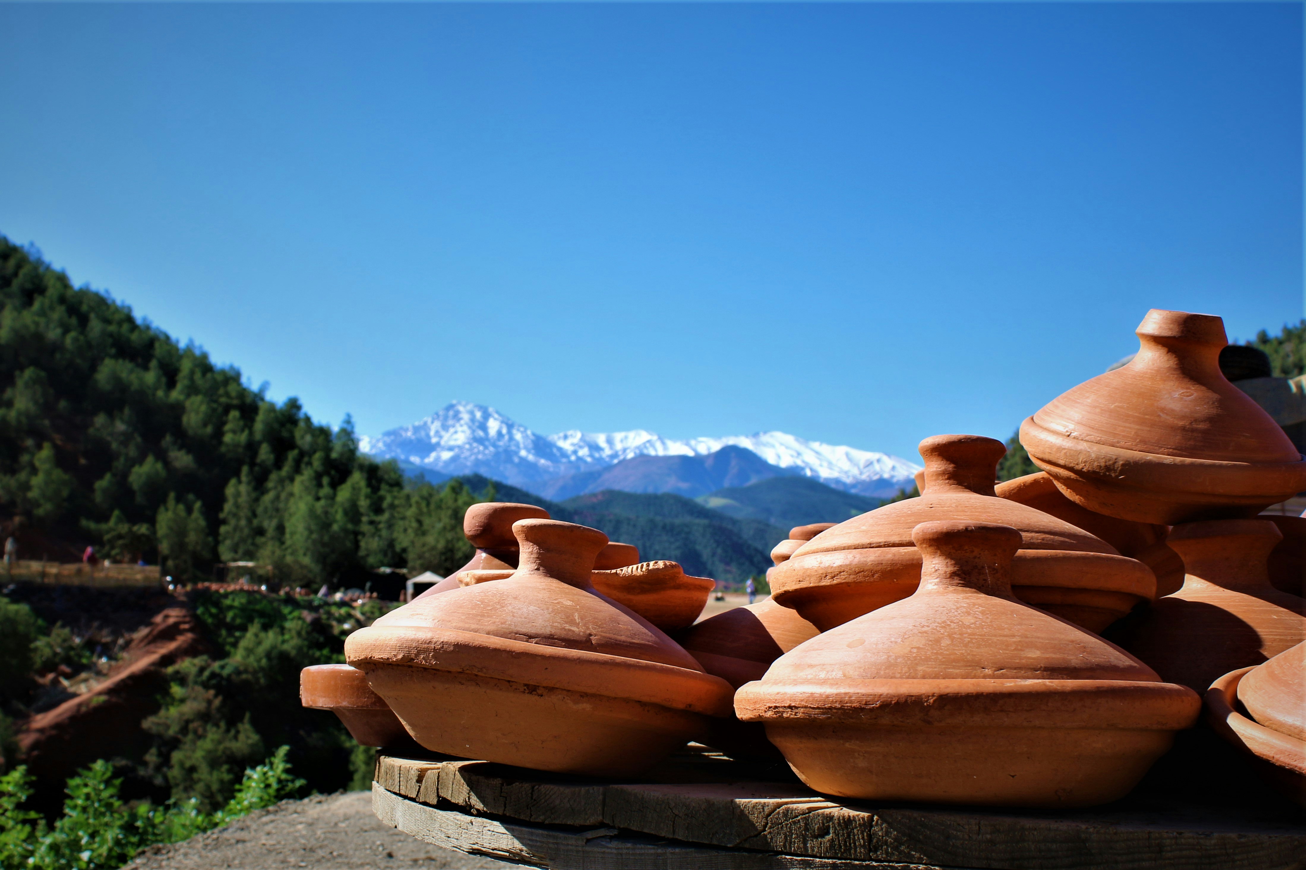 Empty terracotta tagine resting on a linen cloth, traces of saffron sauce on the rim