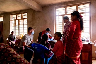 A diverse group of healthcare professionals assisting a child in a clinic.