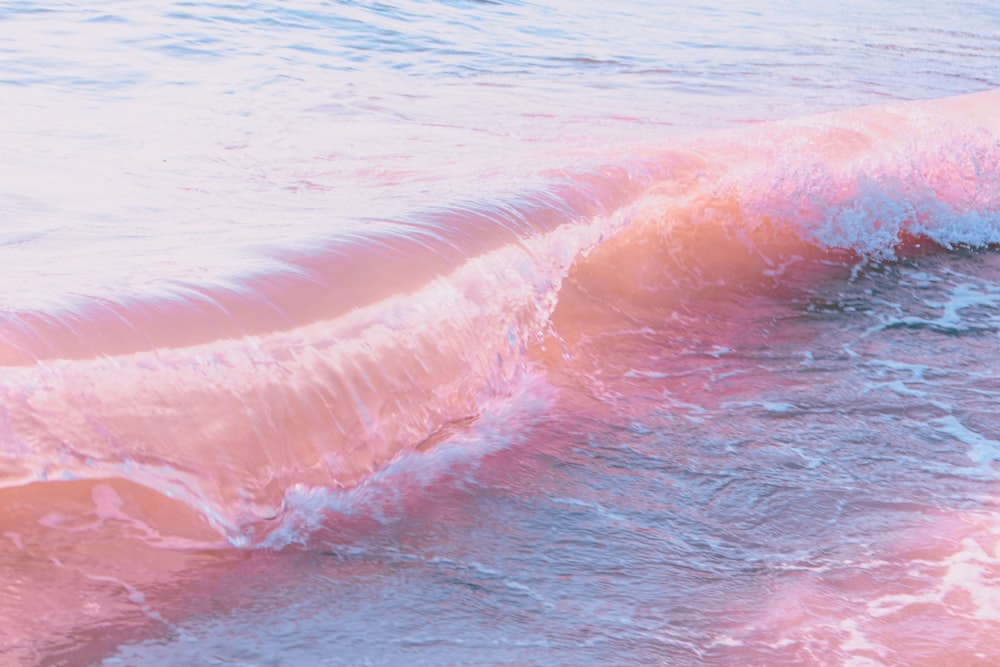 a person riding a surfboard on a wave in the ocean