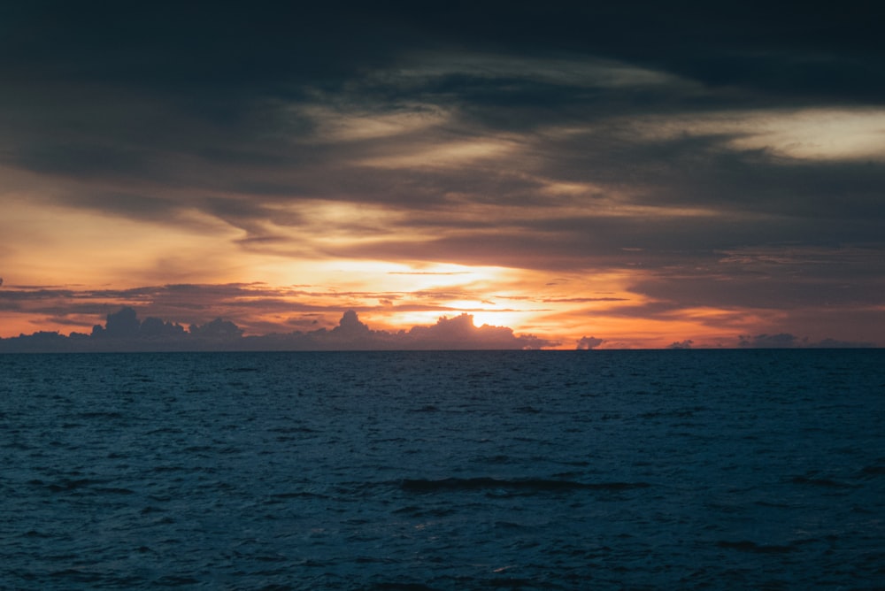 a large body of water under a cloudy sky