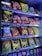 A vending machine filled with a variety of snacks and beverages, including bags of chips and packs of cookies and drinks. The packaging features bright colors and a mix of English and another script, likely Thai.