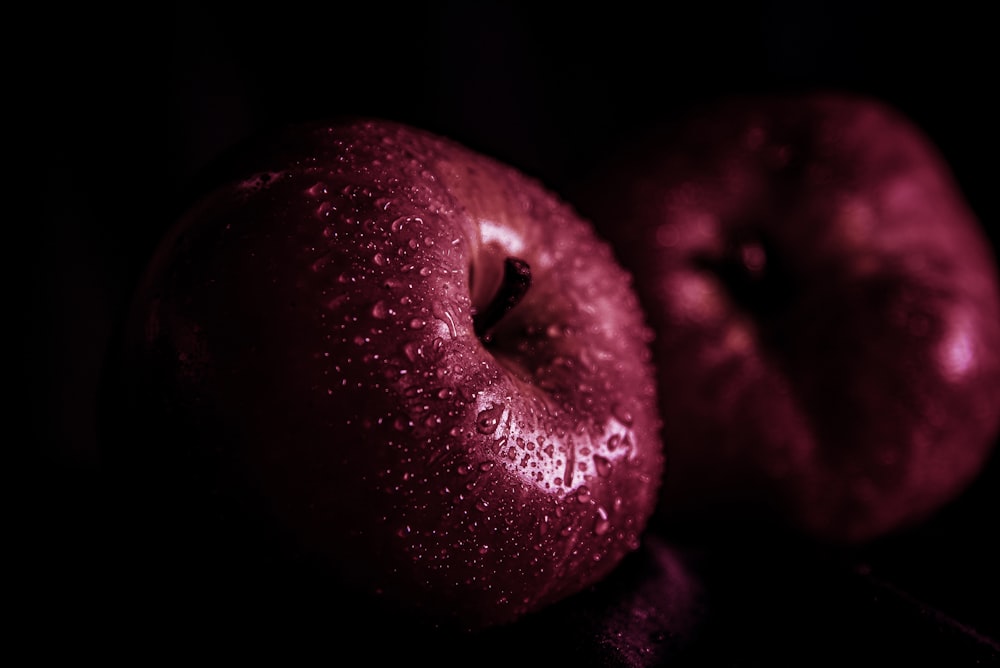 a close up of two apples on a table