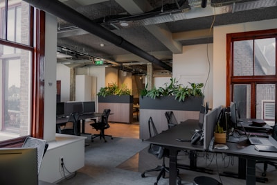 an office with a lot of desks and computers