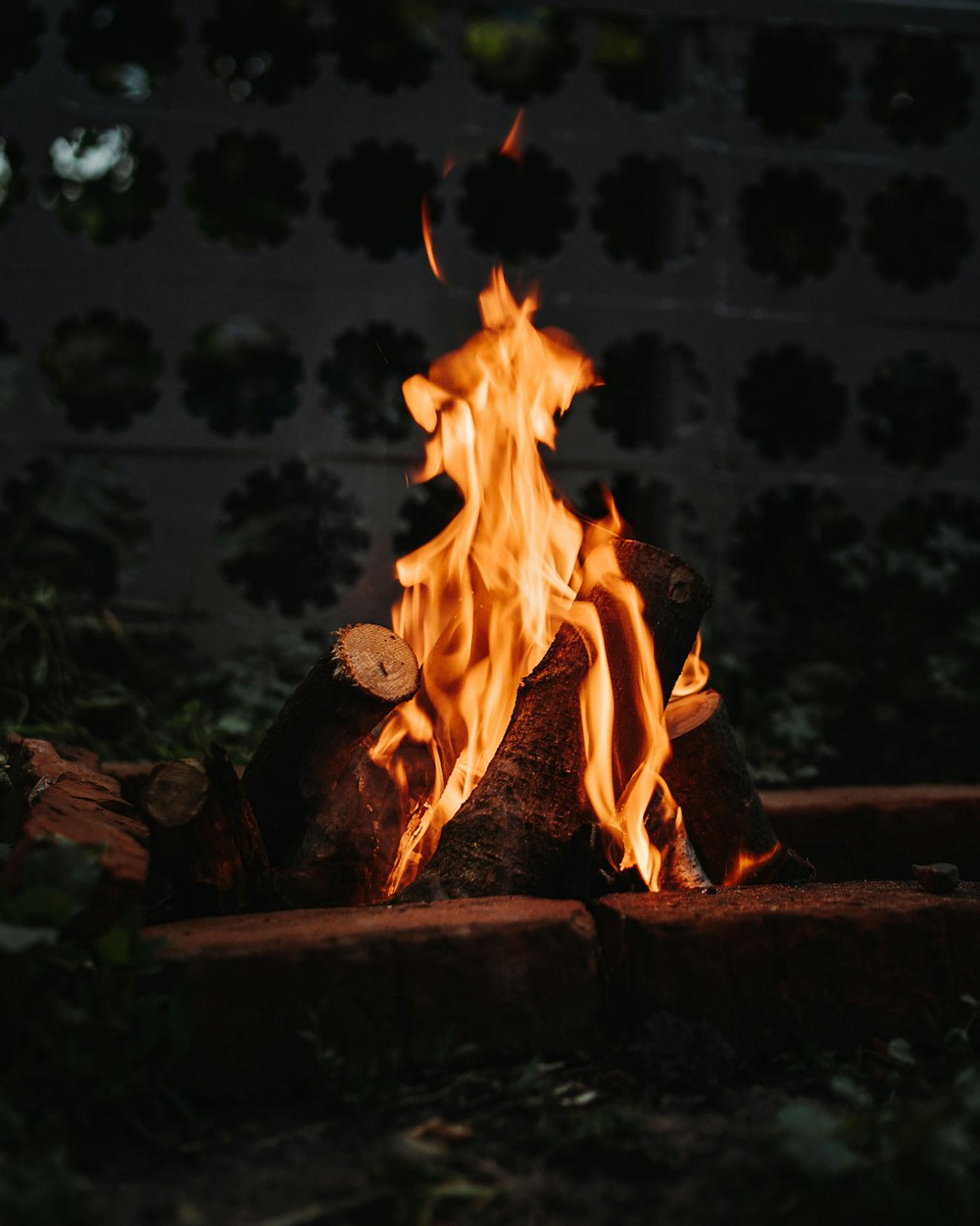 a fire burning in a brick fire pit