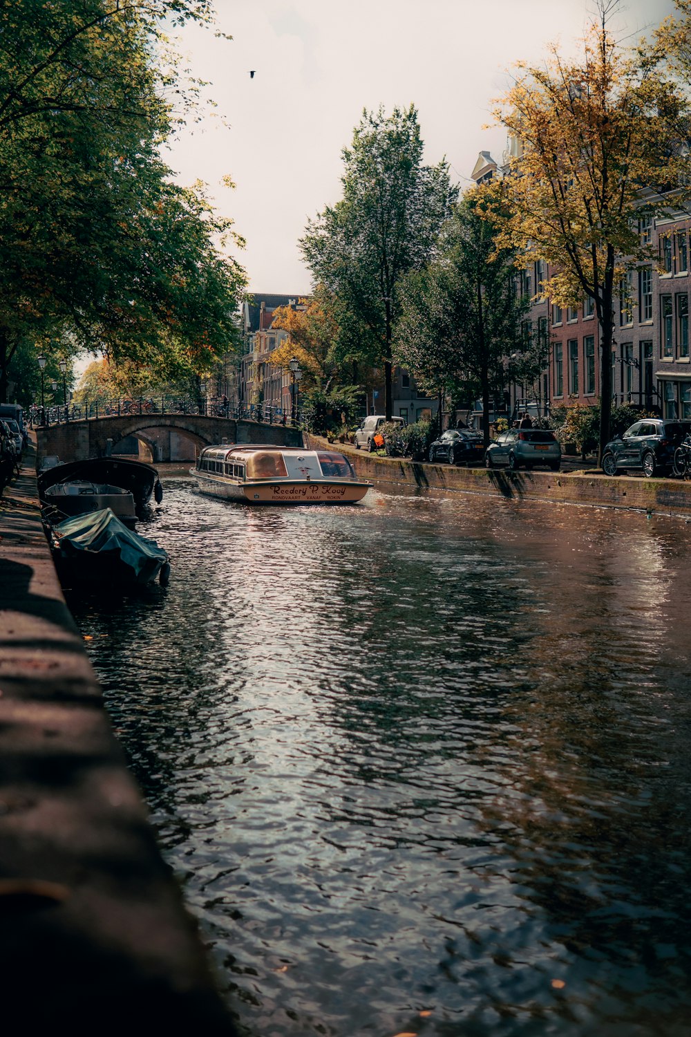 two boats are parked on the side of a river