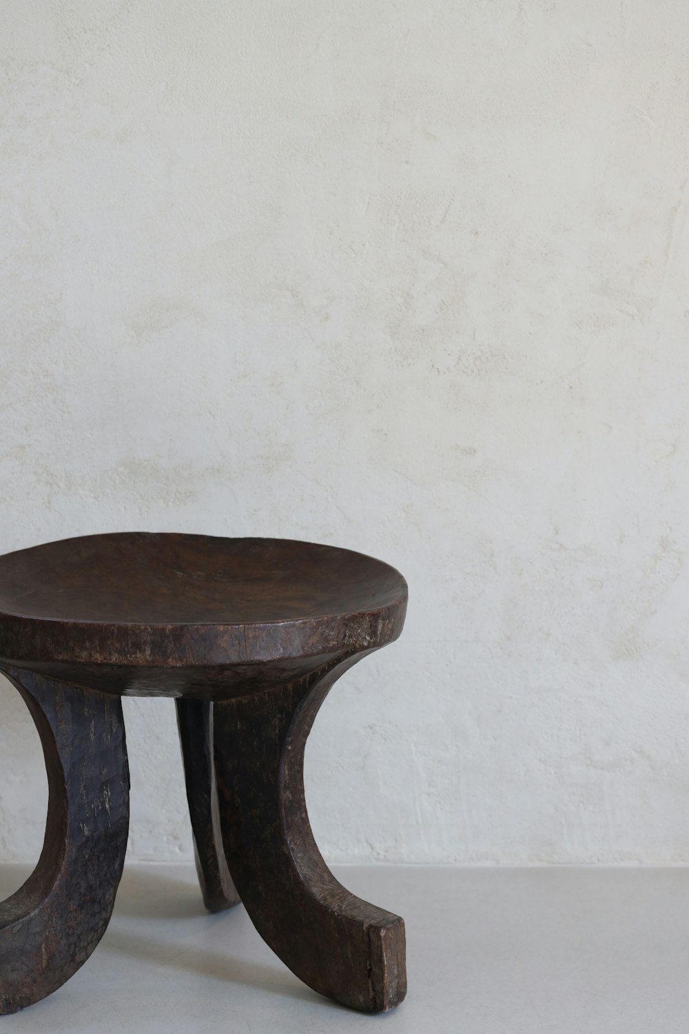 a small wooden table with a circular top