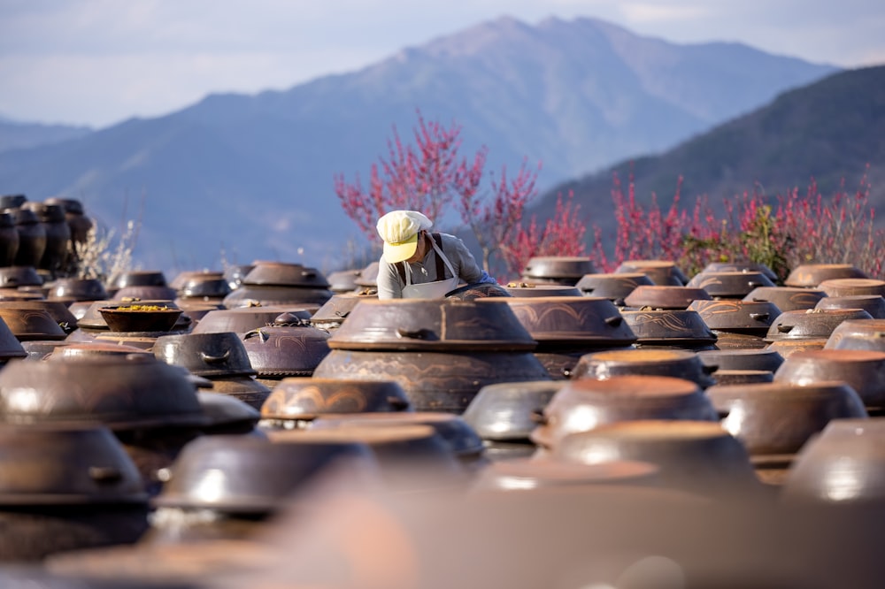 a large group of clay pots sitting on top of a field