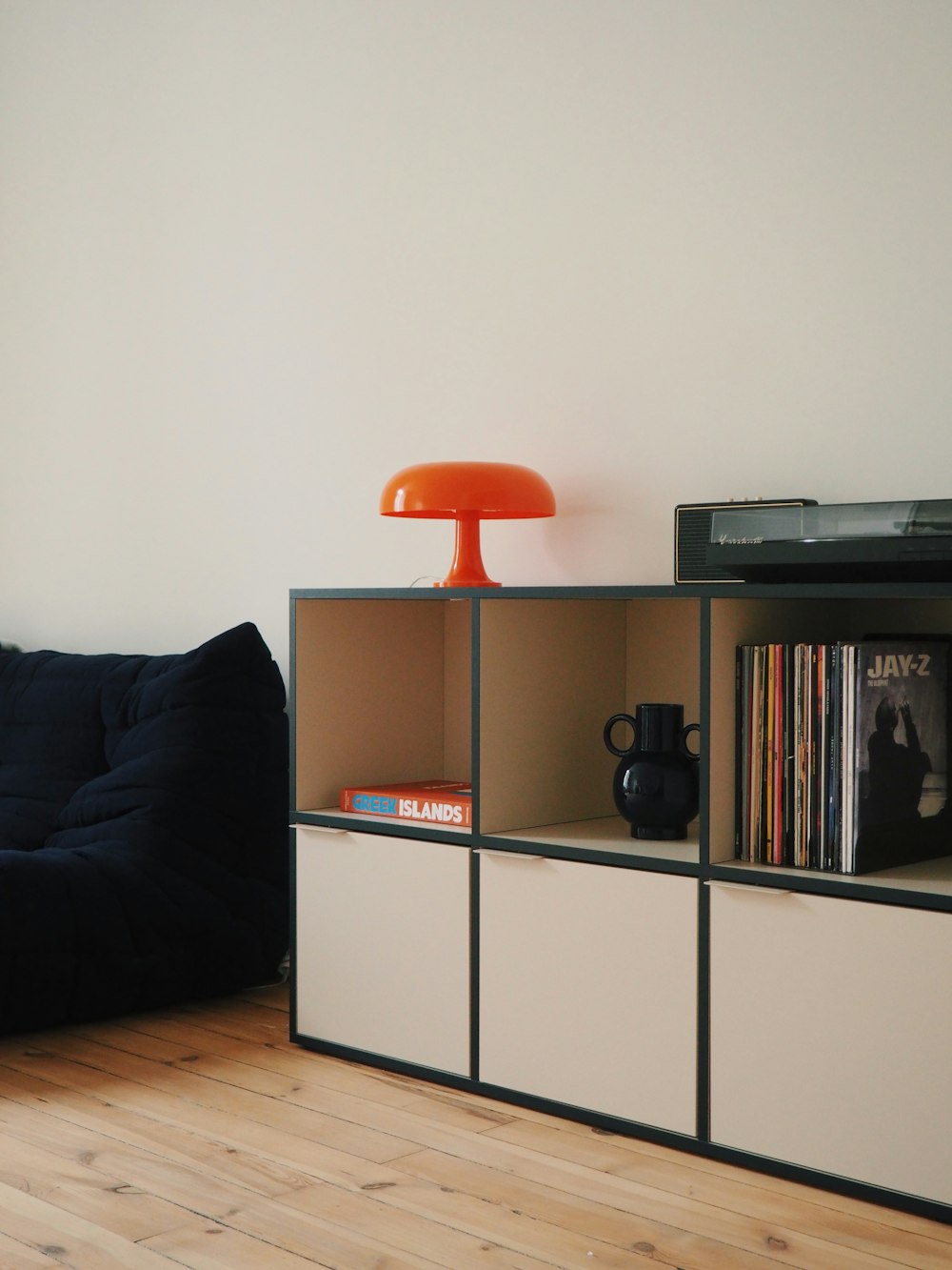 a living room with a couch and a book shelf