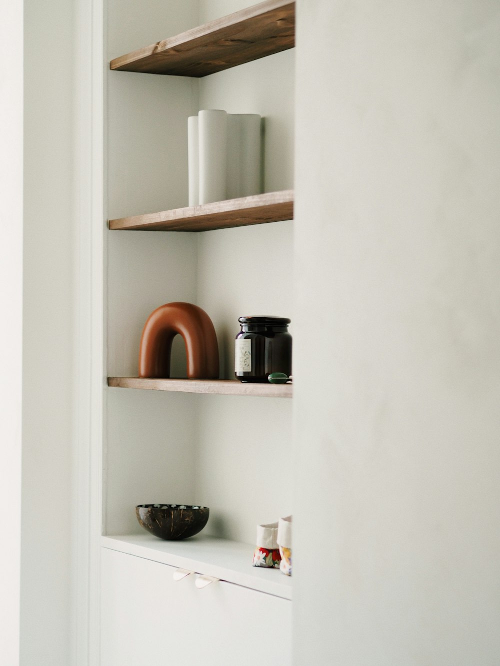 a white wall with shelves filled with various items