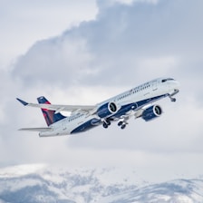 a large jetliner flying through a cloudy sky