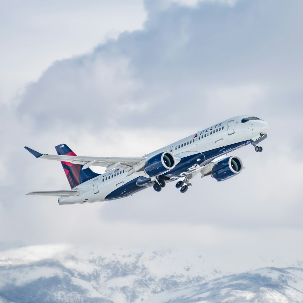 a large jetliner flying through a cloudy sky