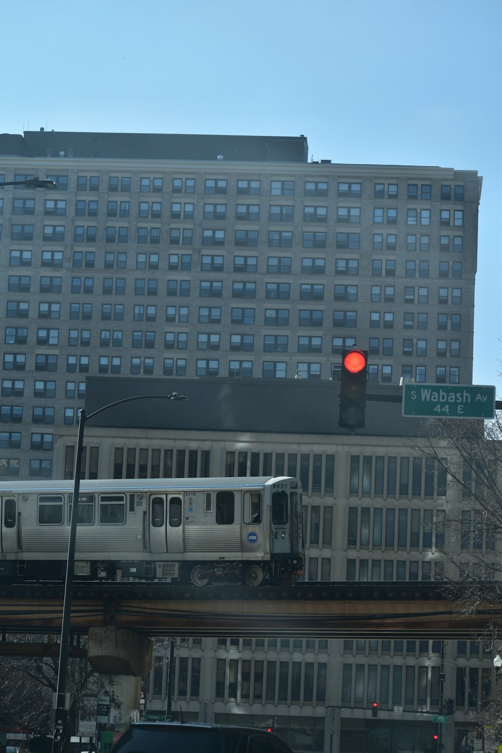 a train on a train track in front of a large building