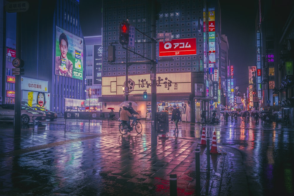 a man riding a bike down a rain soaked street