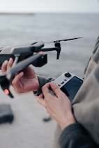 A first responder sharing a moment of encouragement with a youth learning to fly a drone.