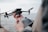 Drone operator controlling the drone during a technical inspection on a construction site.