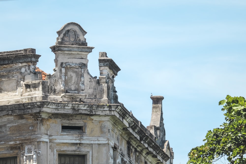 an old building with a clock on the top of it