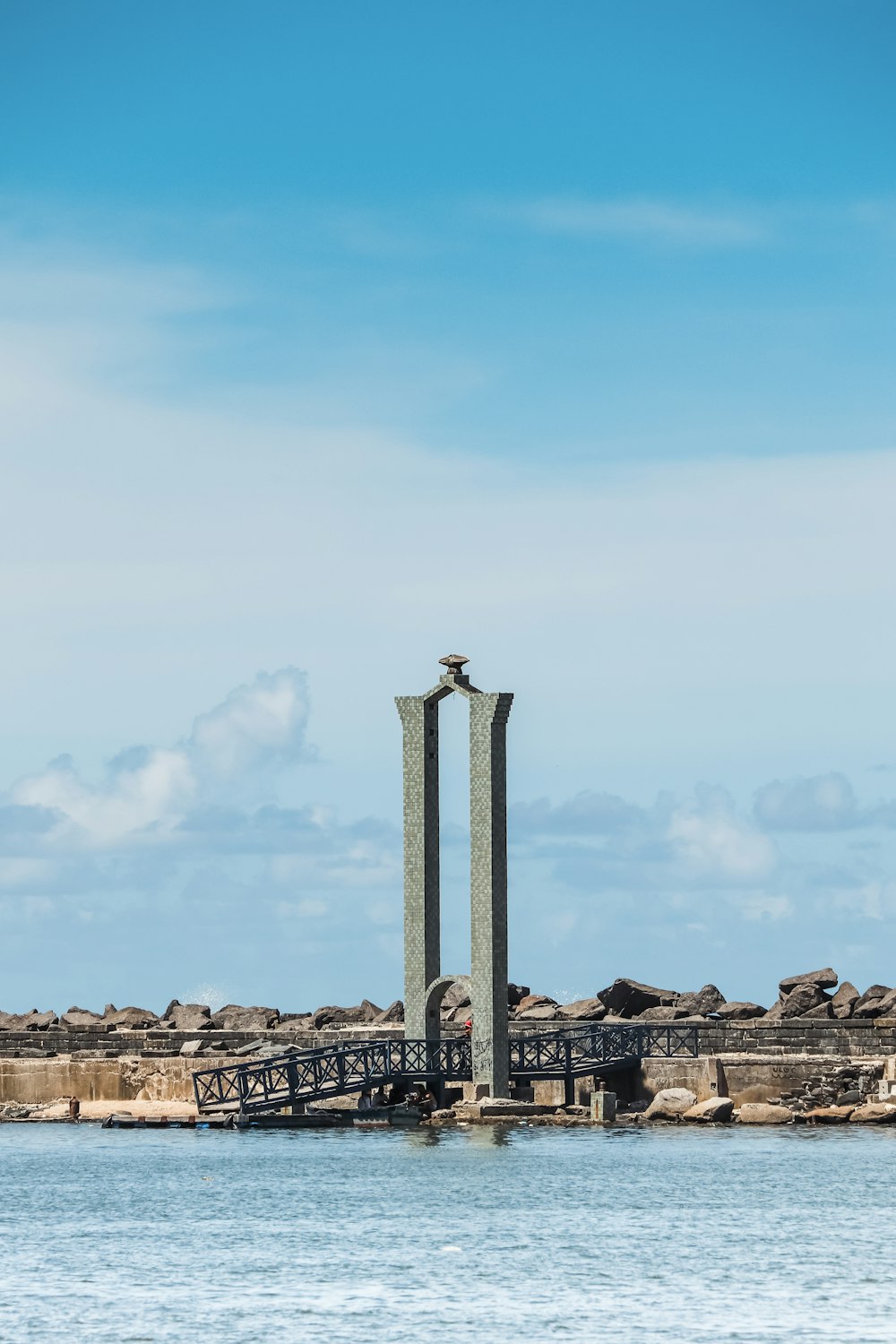 a couple of birds sitting on top of a tall statue