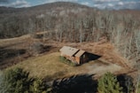 an aerial view of a cabin in the woods