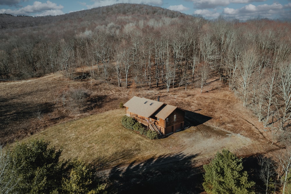 an aerial view of a cabin in the woods