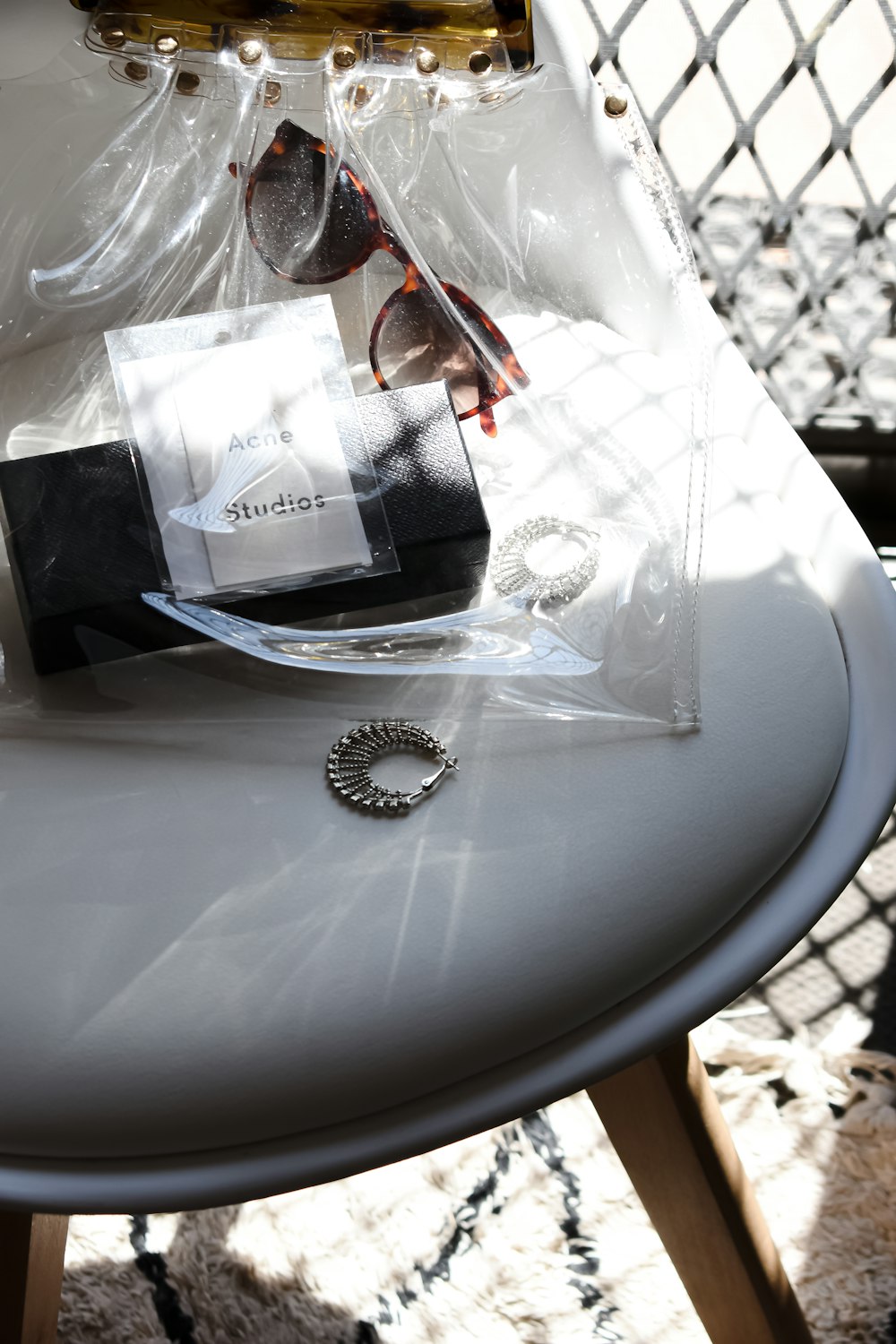 a white table topped with a bag and a pair of sunglasses