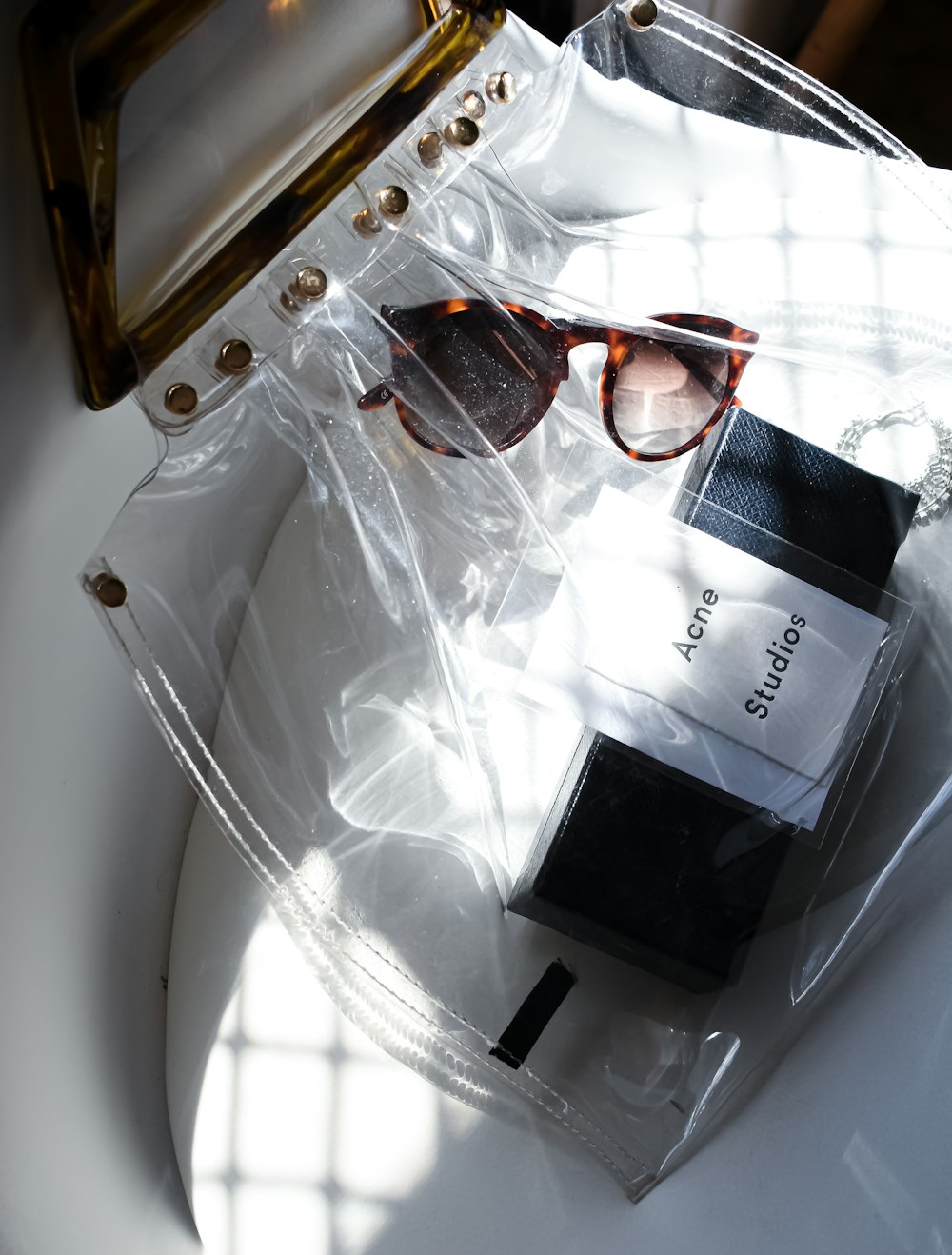 a pair of sunglasses sitting on top of a toilet