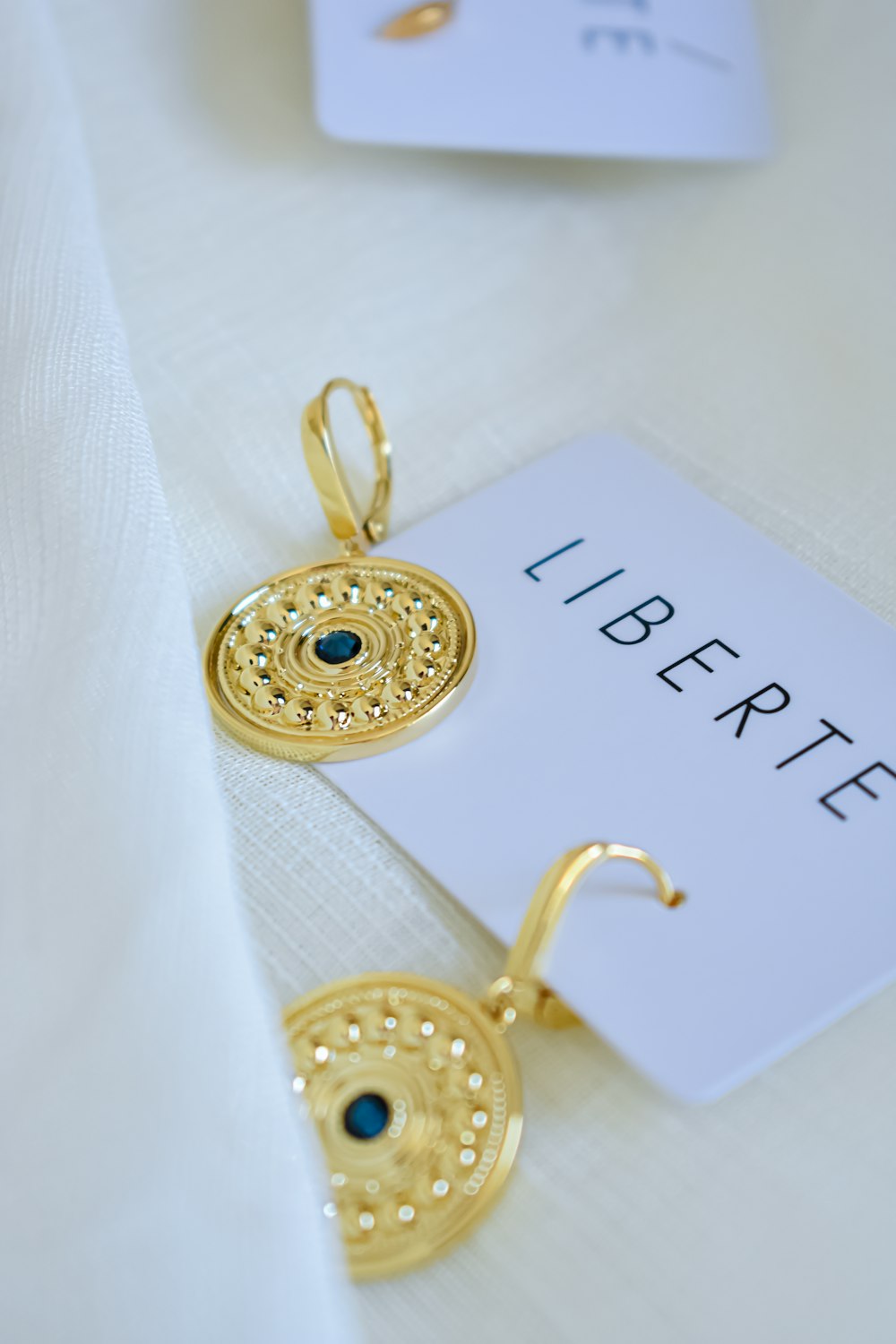 a close up of a pair of earrings on a table